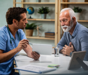 caregiver showing tablet to senior