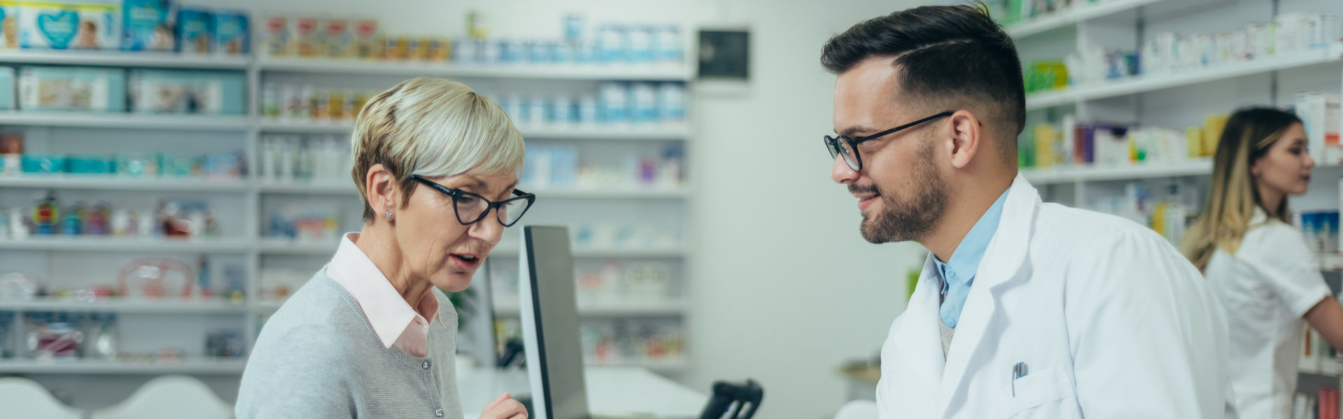 pharmacist checking woman prescription